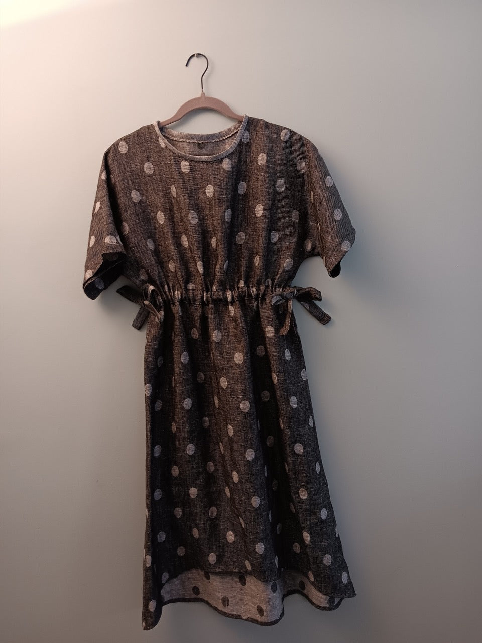 Polka dot linen dress with side ties, ideal for sewing projects and fashion apparel
