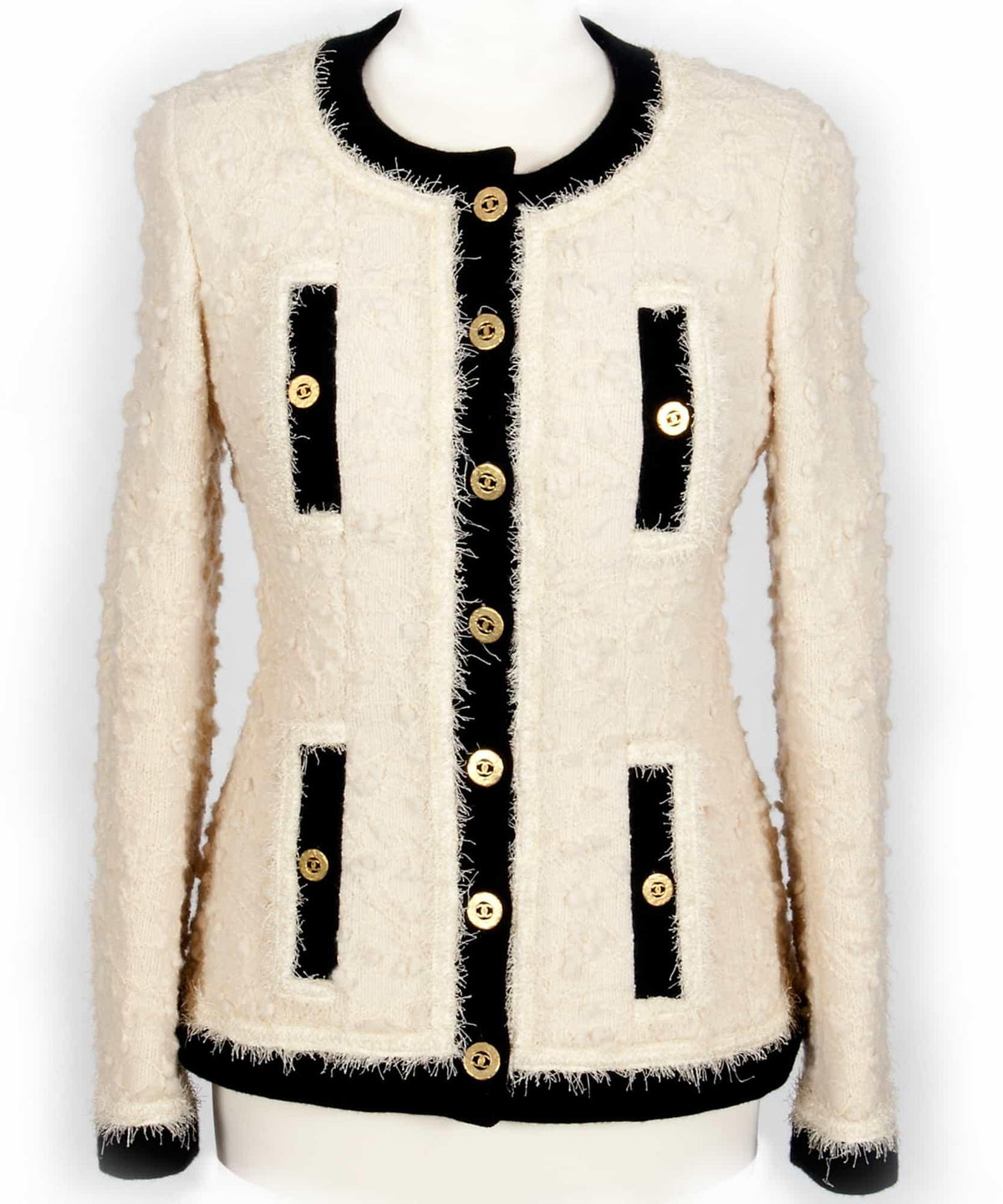 Cream tweed jacket with black trim and gold buttons, ideal for designer apparel sewing projects