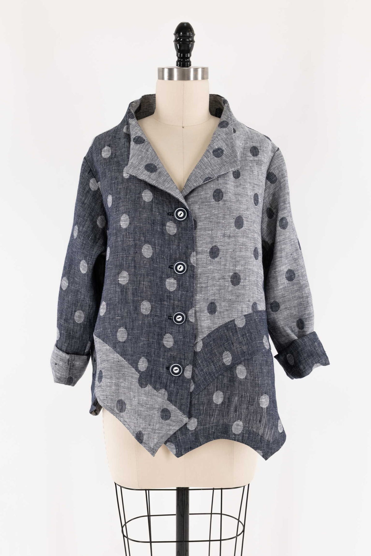 Gray and navy polka dot button-up jacket on mannequin, ideal for sewing apparel and creative fashion projects.