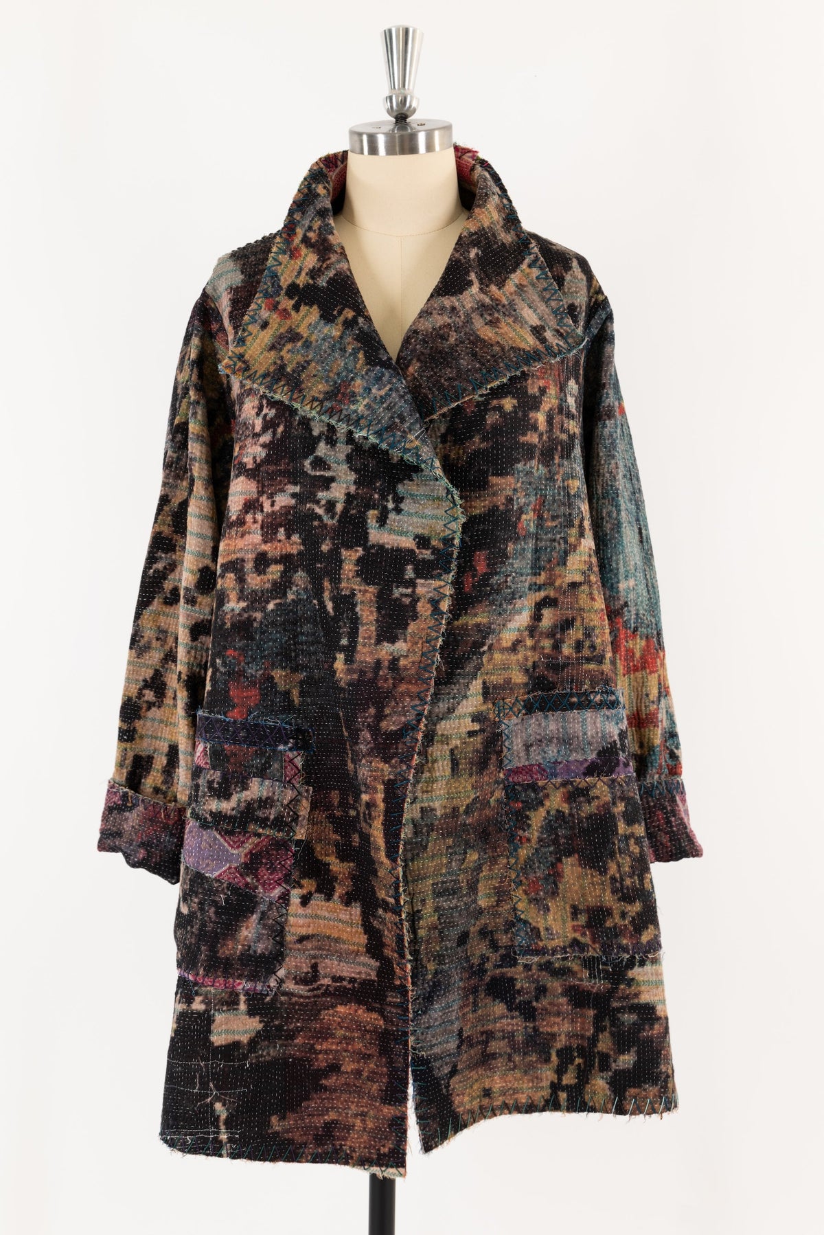 Patchwork coat with abstract print and decorative stitching, ideal for creative sewing projects