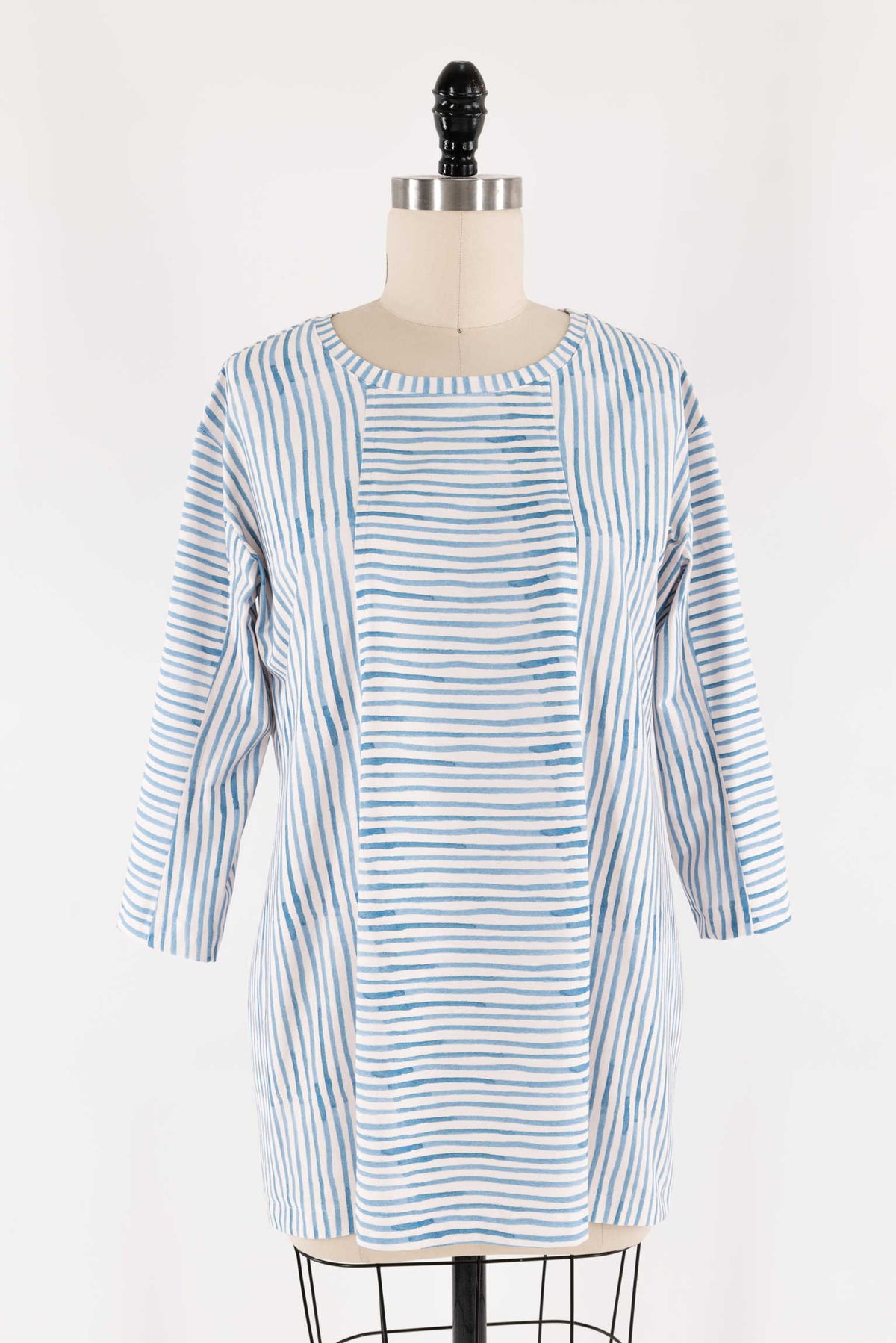 Blue and white striped tunic dress on mannequin, ideal for sewing projects with cotton or linen fabric