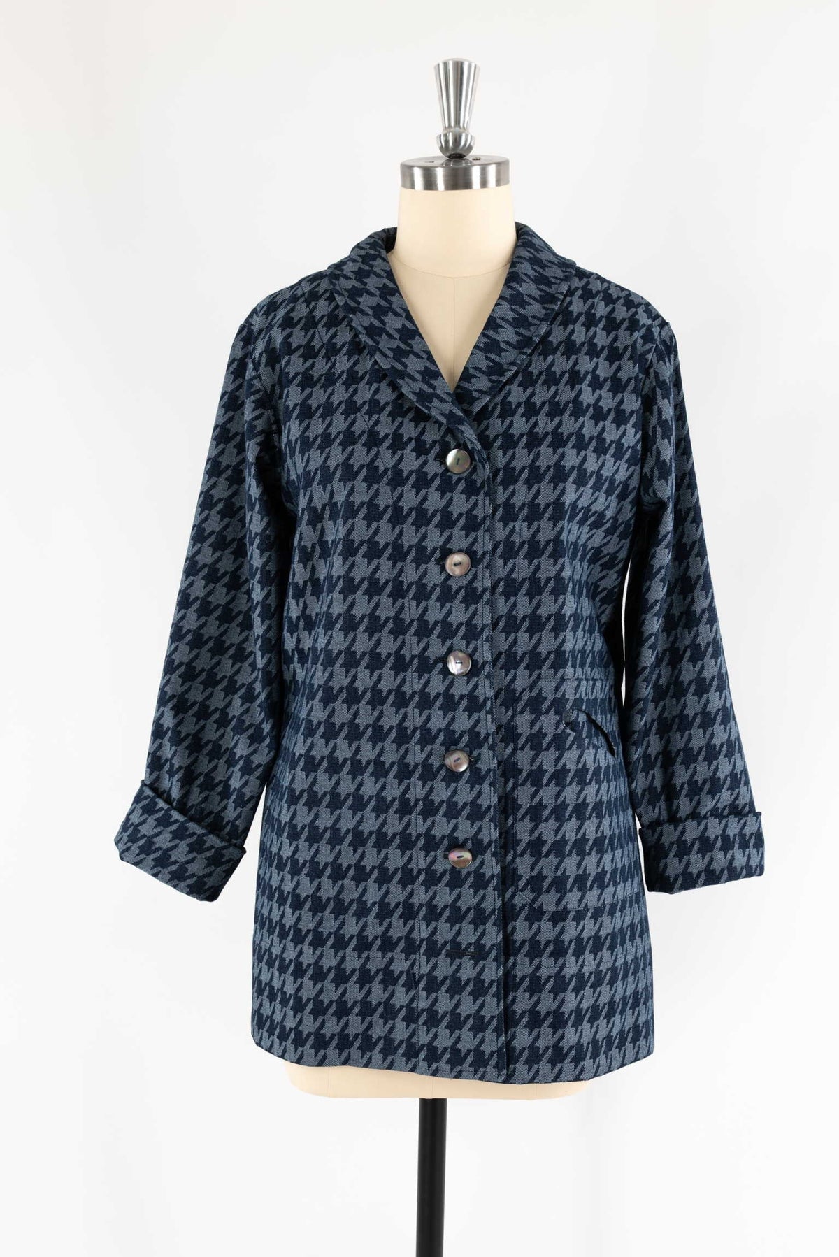 Blue houndstooth wool coat with buttons, displayed on mannequin for sewing and fashion projects