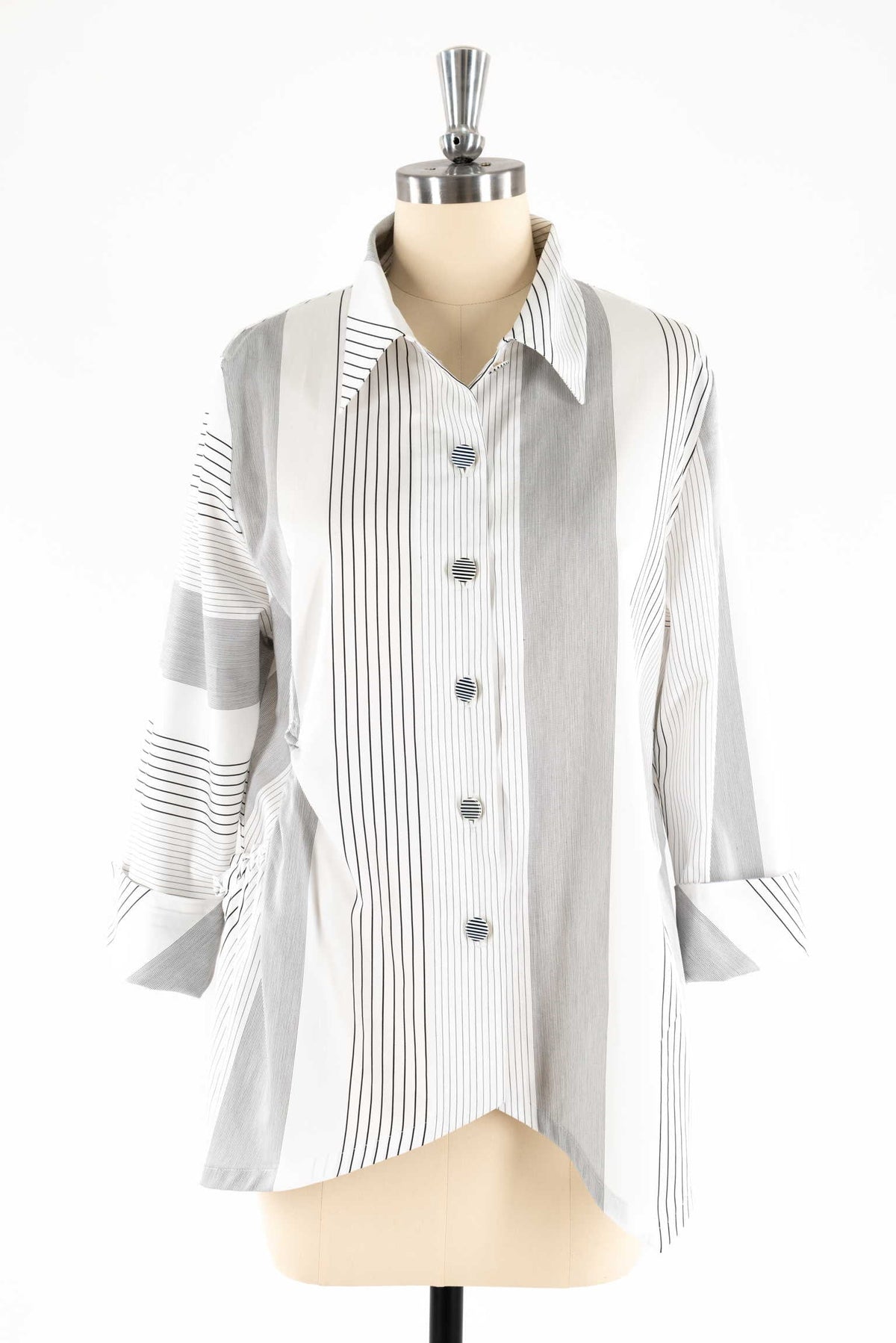 Striped button-up shirt with long sleeves on mannequin, ideal for sewing projects