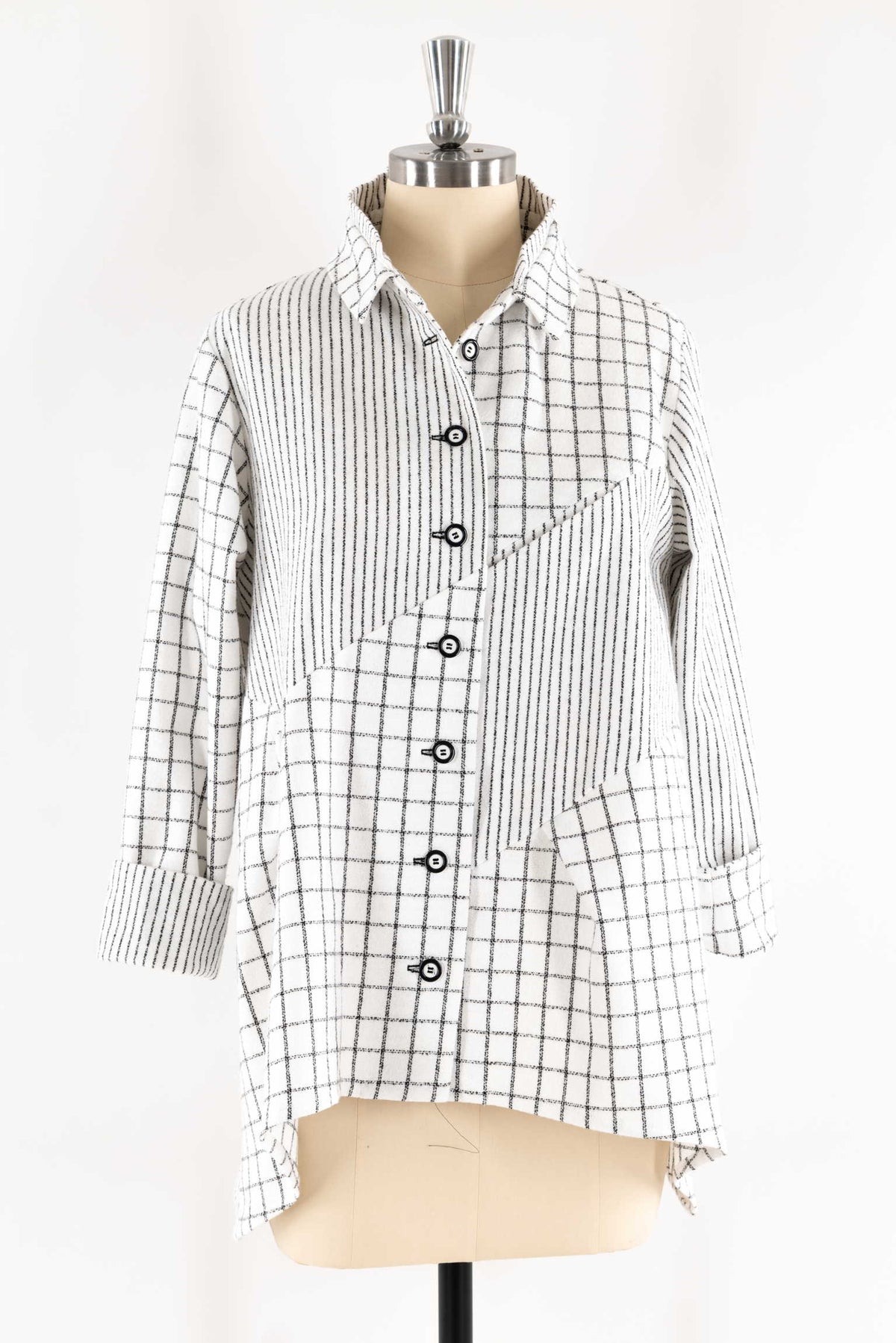 Black and white grid pattern shirt with button front, displayed on mannequin for sewing projects