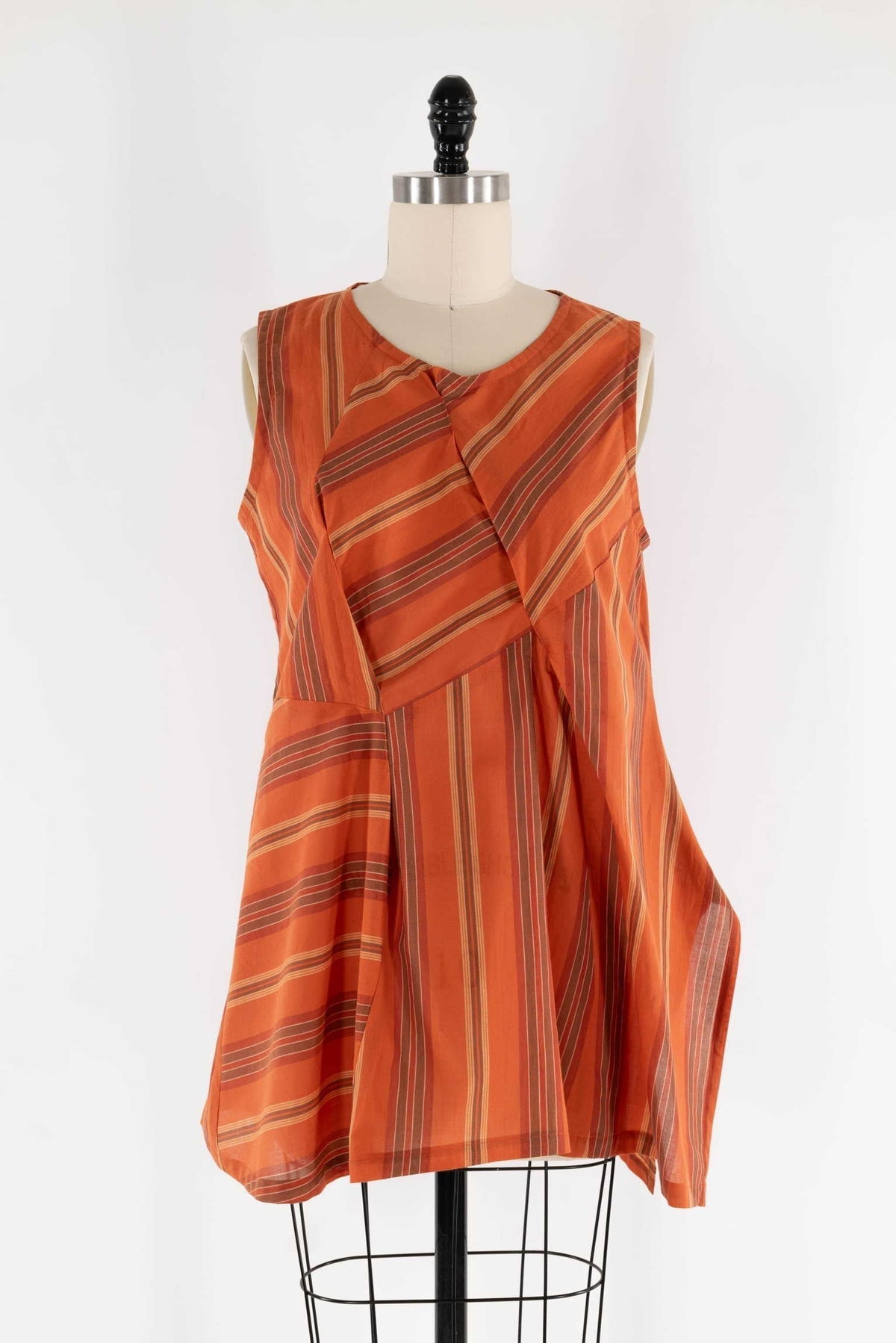 Orange striped sleeveless tunic top on mannequin, ideal for sewing apparel or fashion projects