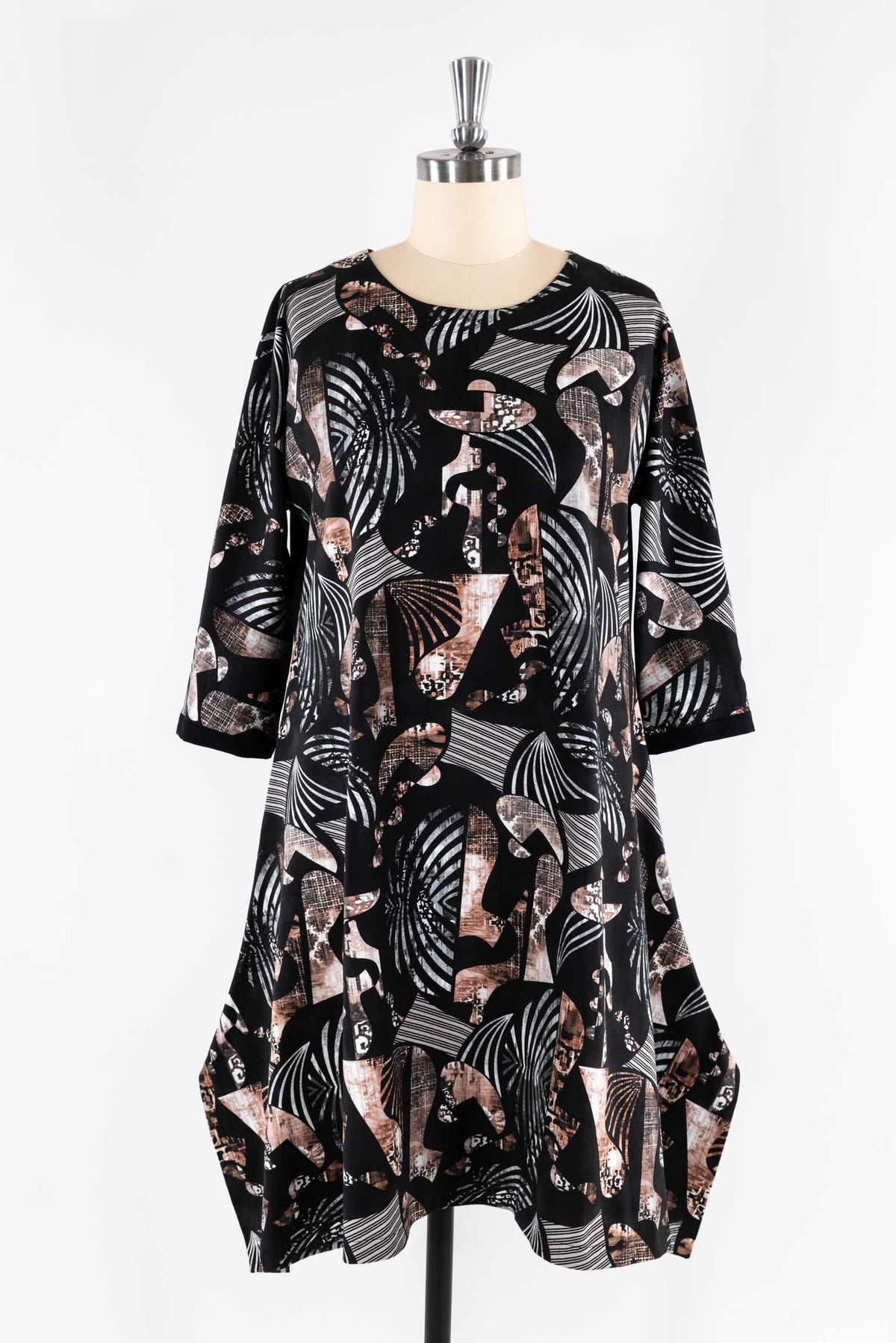 Abstract geometric print dress in black, white, and bronze on mannequin, ideal for sewing apparel
