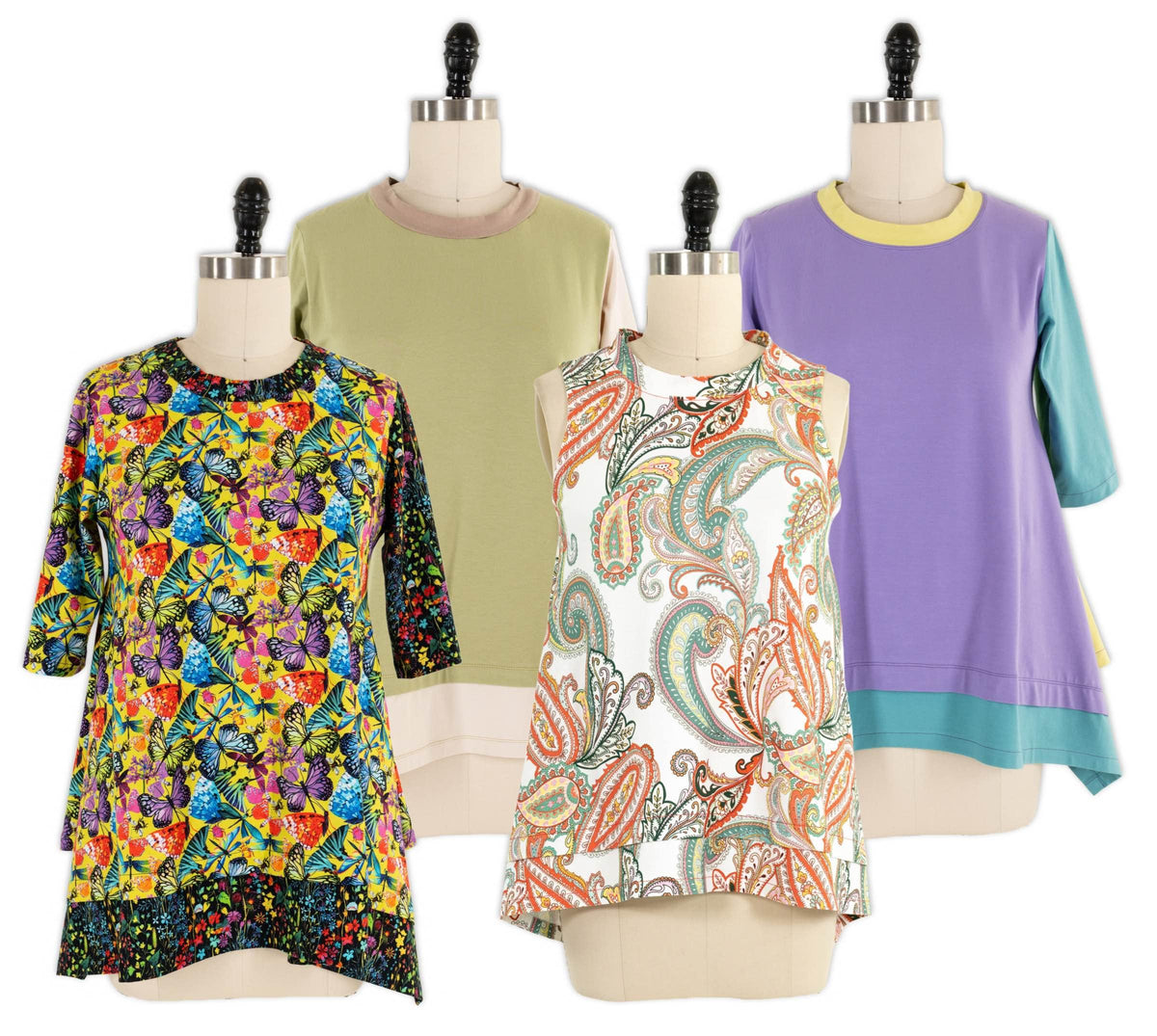 Colorful butterfly and paisley print tops on mannequins, showcasing vibrant fabric designs for sewing projects
