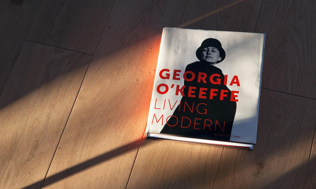 Georgia O'Keeffe: Living Modern art book on wooden floor with sunlight