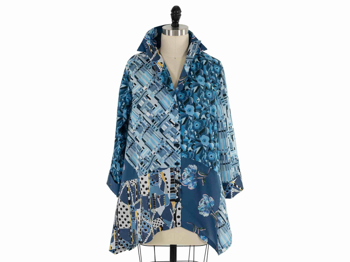 Blue abstract floral and geometric print shirt dress on mannequin, ideal for sewing apparel or quilting projects