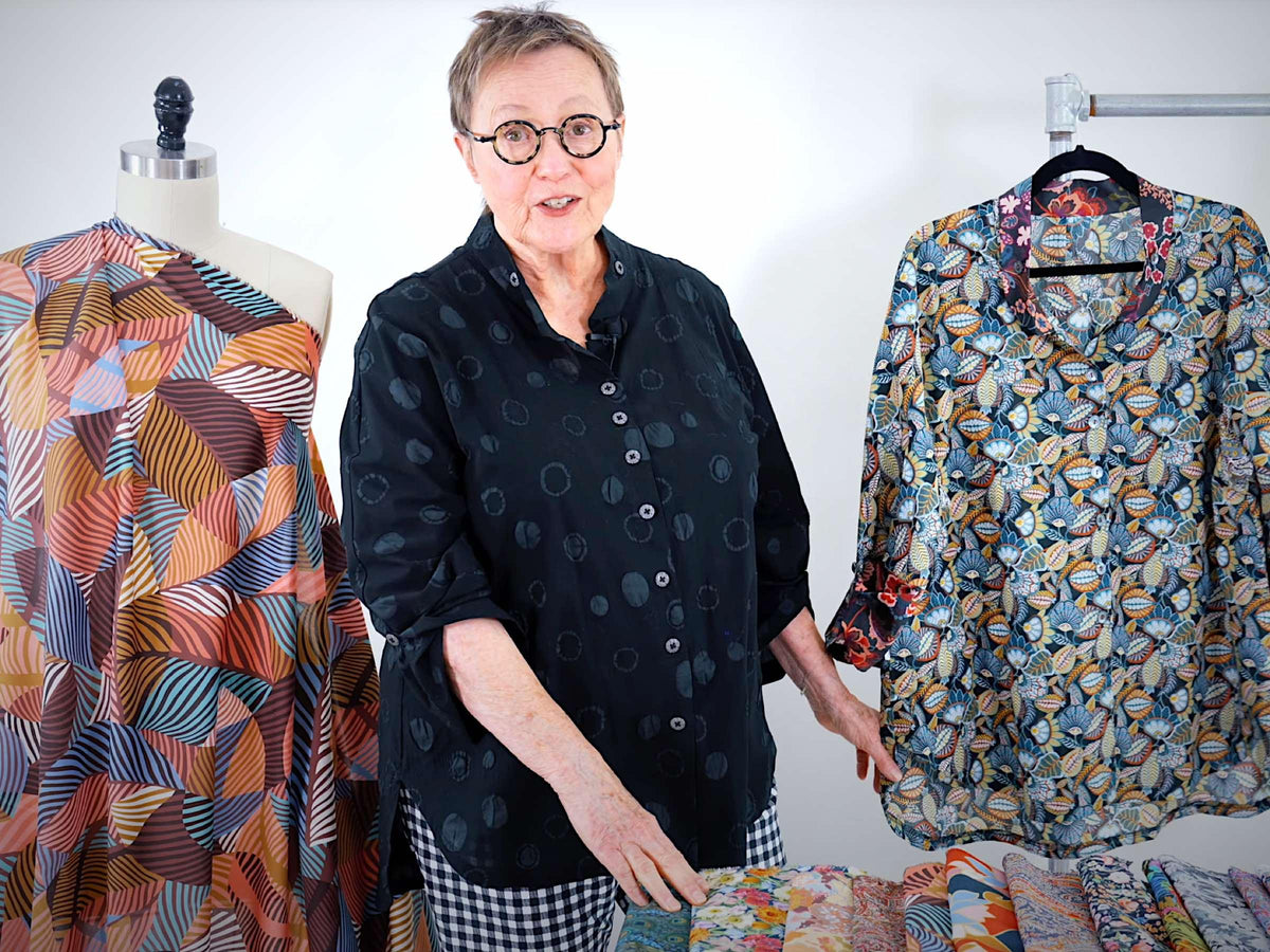 Woman showcasing patterned fabric garments and textile designs for sewing and apparel creation