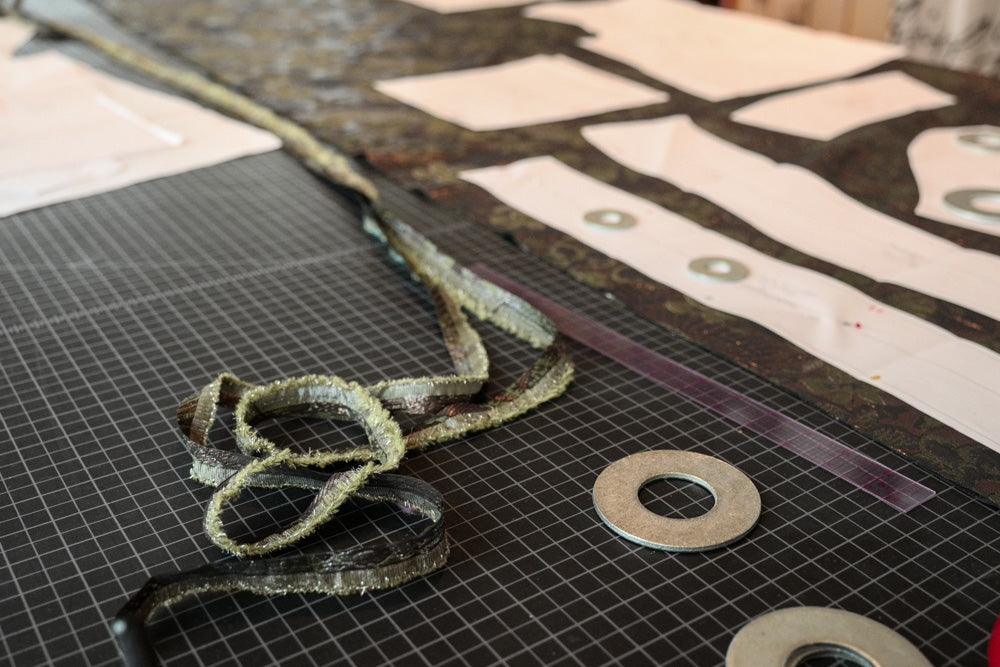Textured fabric strips and pattern pieces on cutting mat for sewing projects