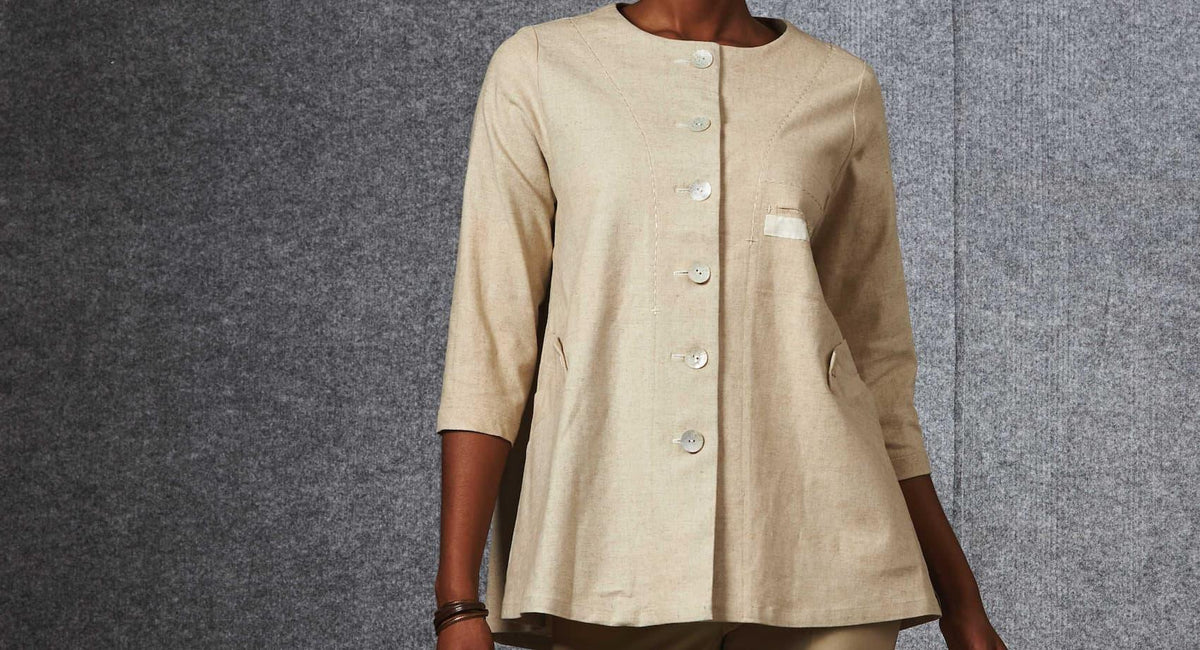 Beige linen button-up tunic with patch pockets, ideal for sewing apparel and fashion projects