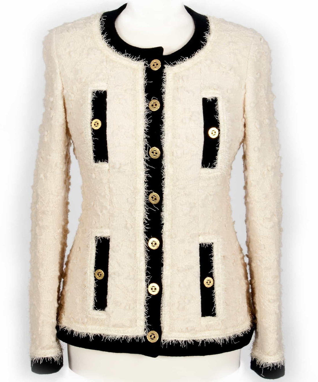 Cream tweed jacket with black trim and gold buttons, ideal for designer apparel sewing projects