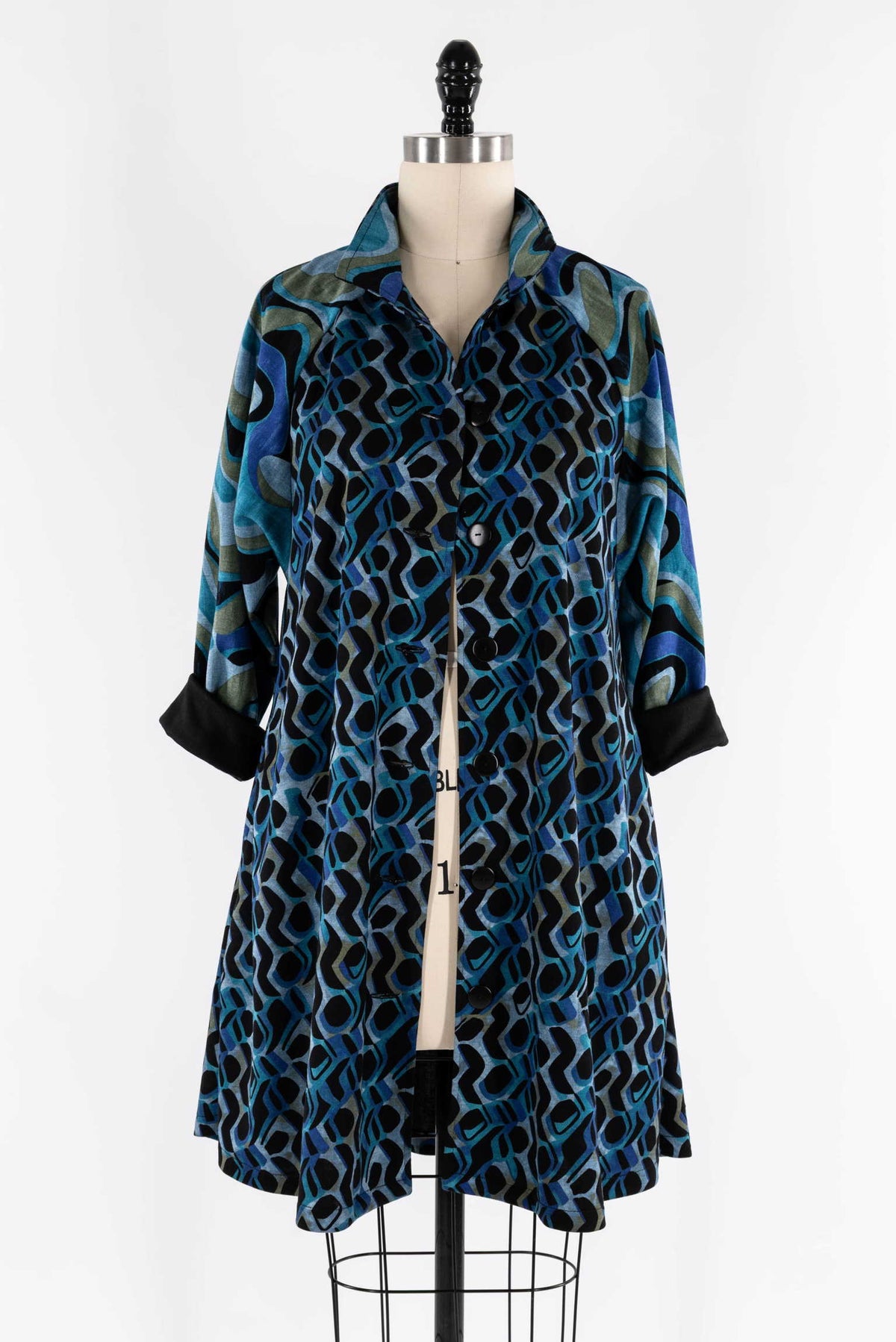 Blue and black abstract print button-up shirt dress on mannequin, ideal for creative sewing projects