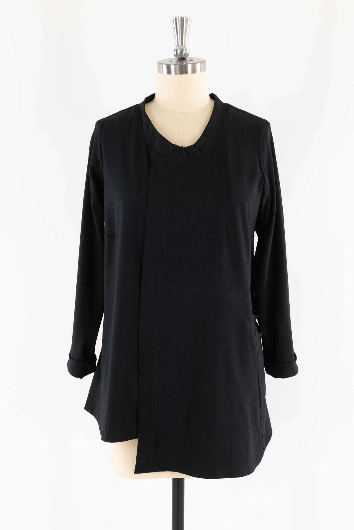 Black long-sleeve tunic with ruffled neckline and side pockets, ideal for sewing apparel projects