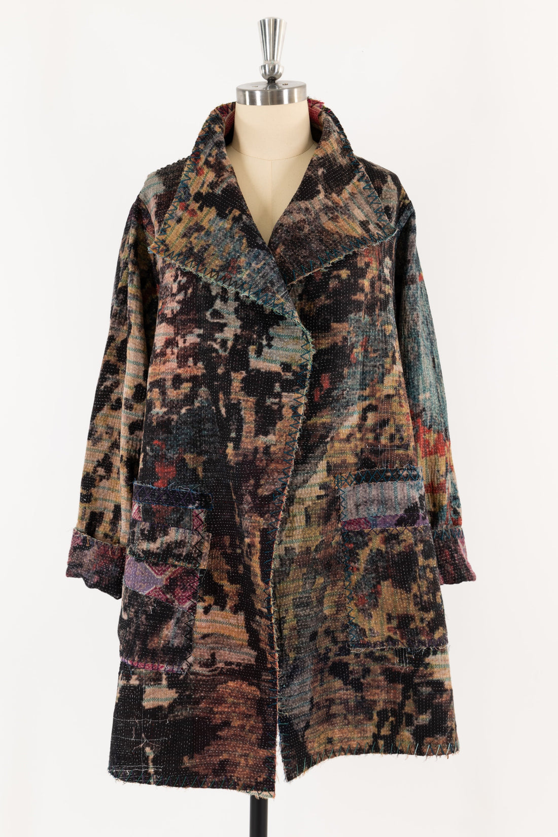 Patchwork coat with abstract print and decorative stitching, ideal for creative sewing projects