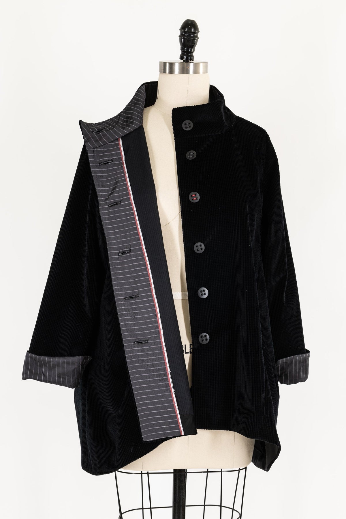 Black corduroy jacket with striped lining, button front, displayed on mannequin for sewing projects