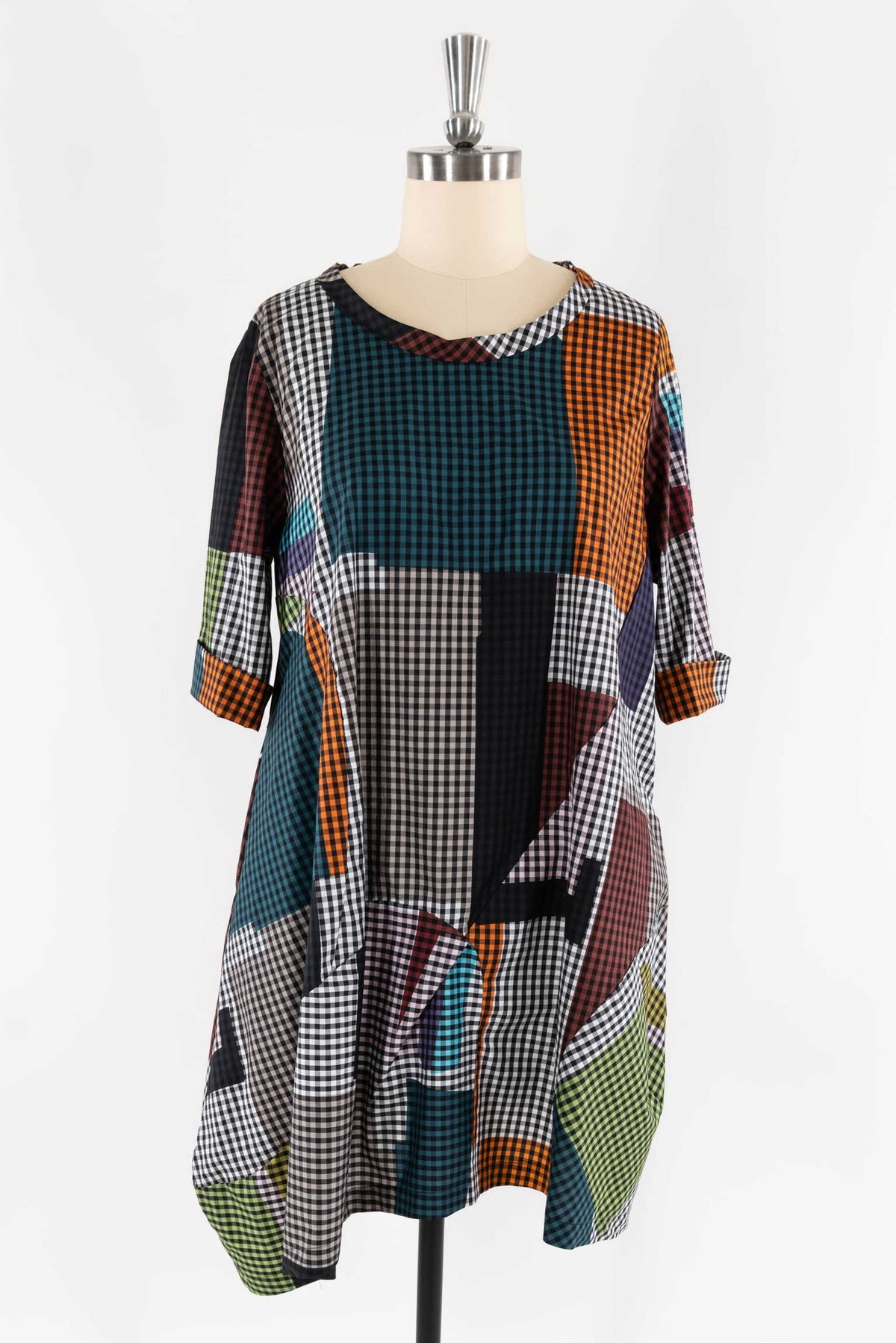 Colorful patchwork dress with gingham patterns, perfect for creative sewing projects and fashion design.