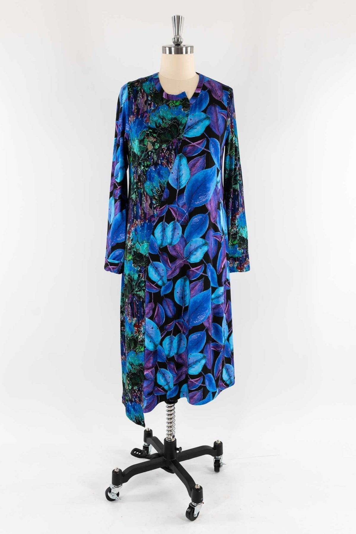 Vibrant blue and purple leaf print dress on mannequin, ideal for creative sewing projects with designer fabrics.
