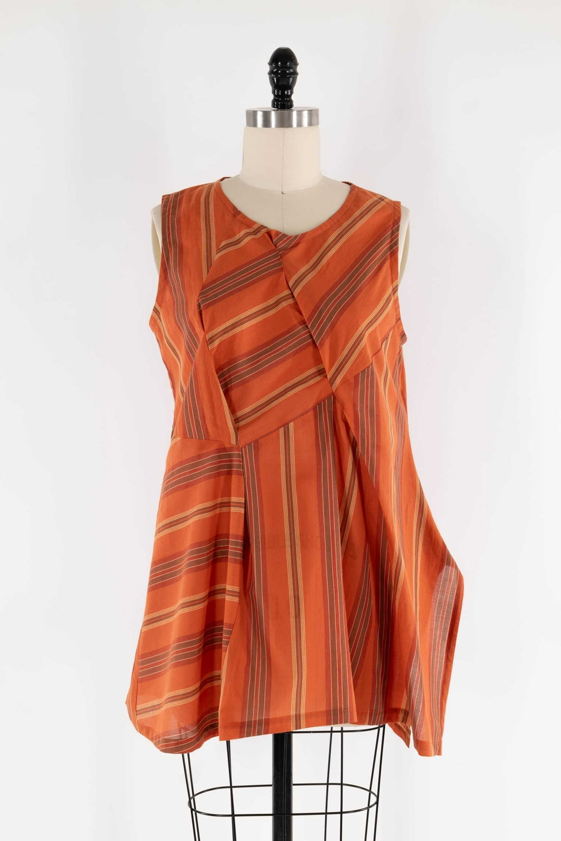 Orange striped sleeveless tunic top on mannequin, ideal for sewing apparel or fashion projects