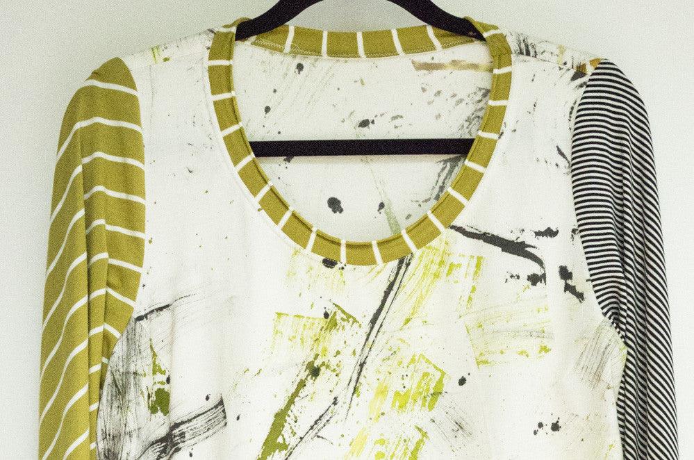 Abstract print top with striped sleeves and green trim, ideal for fashion sewing projects