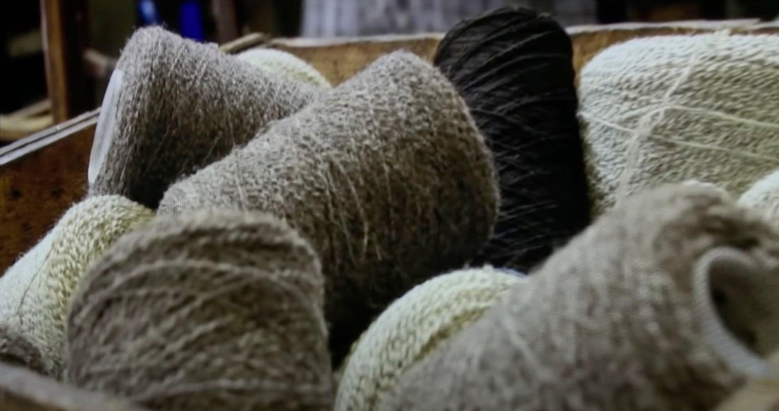 Textured fabric bolts in neutral tones, ideal for sewing and quilting projects