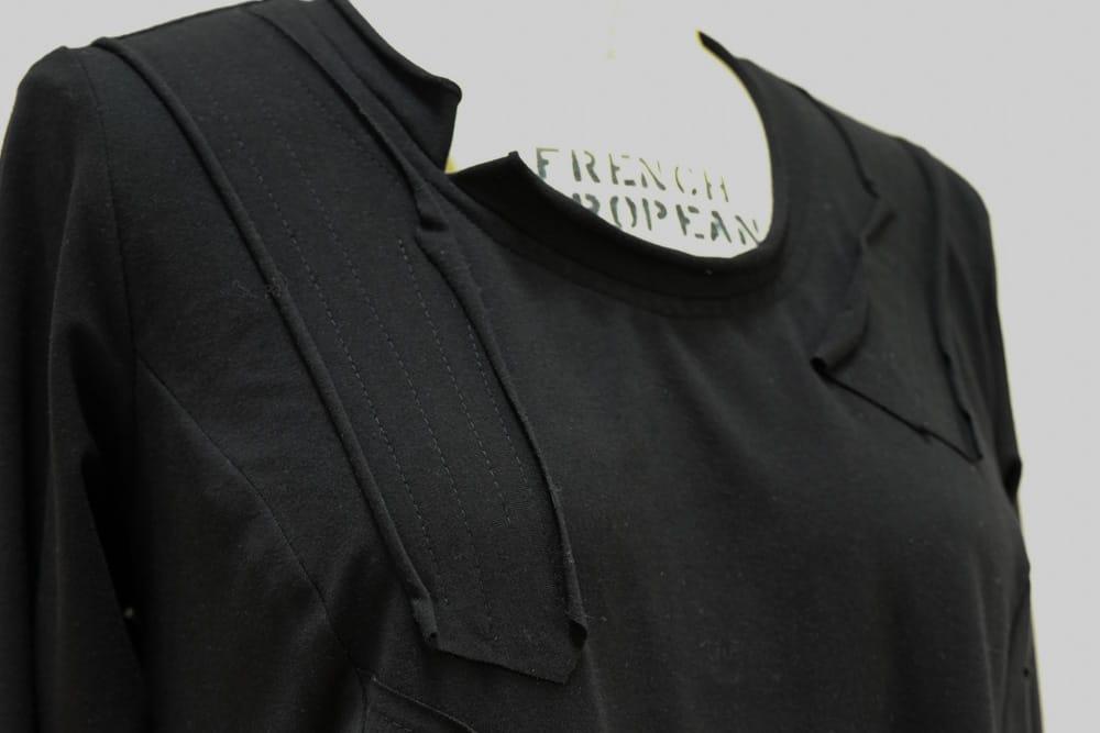 Black long-sleeve knit top with pleated neckline detail, ideal for apparel sewing projects