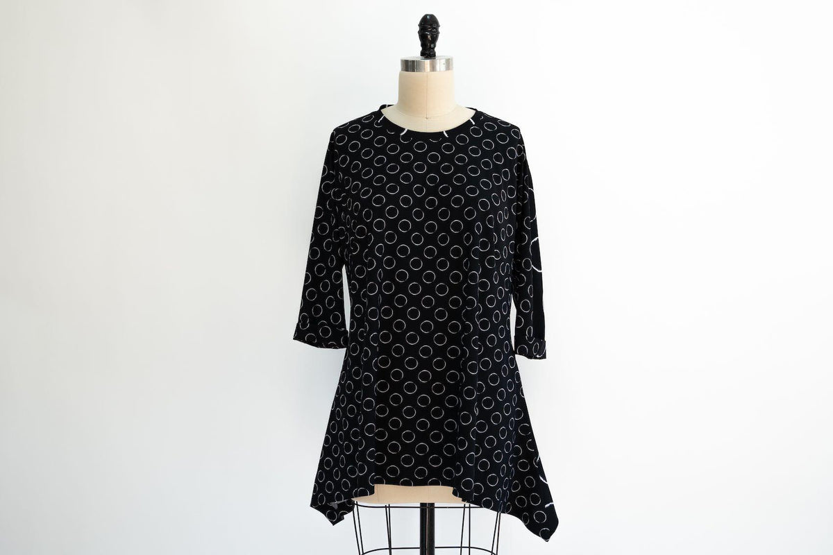 Black dress with white circle print on mannequin, ideal for sewing apparel or fashion projects