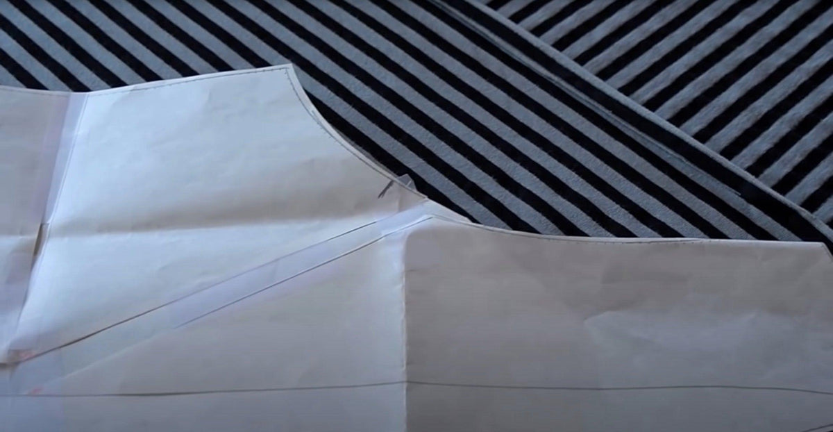 Black and white striped fabric with sewing pattern overlay for apparel design