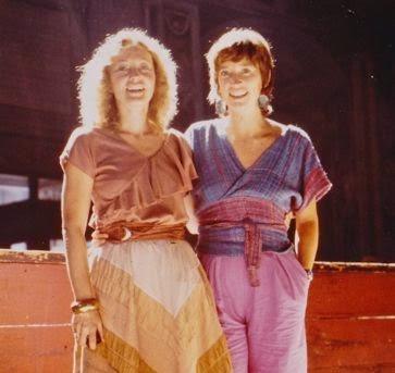 Two women smiling in stylish wrap tops and pants, showcasing fashion fabric designs for sewing projects