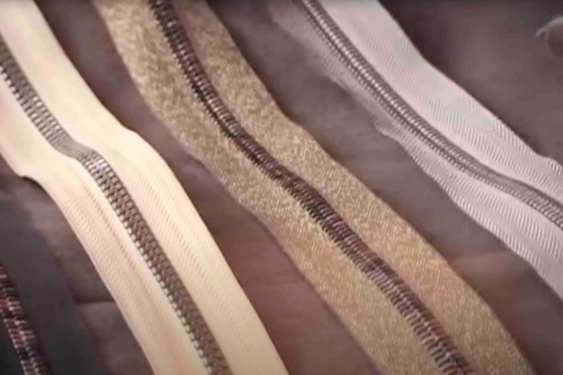 Assorted fabric zippers in neutral tones for sewing and apparel projects