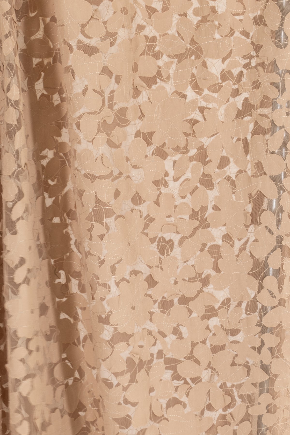 Tan floral lace fabric with sheer overlay, ideal for apparel and creative sewing projects