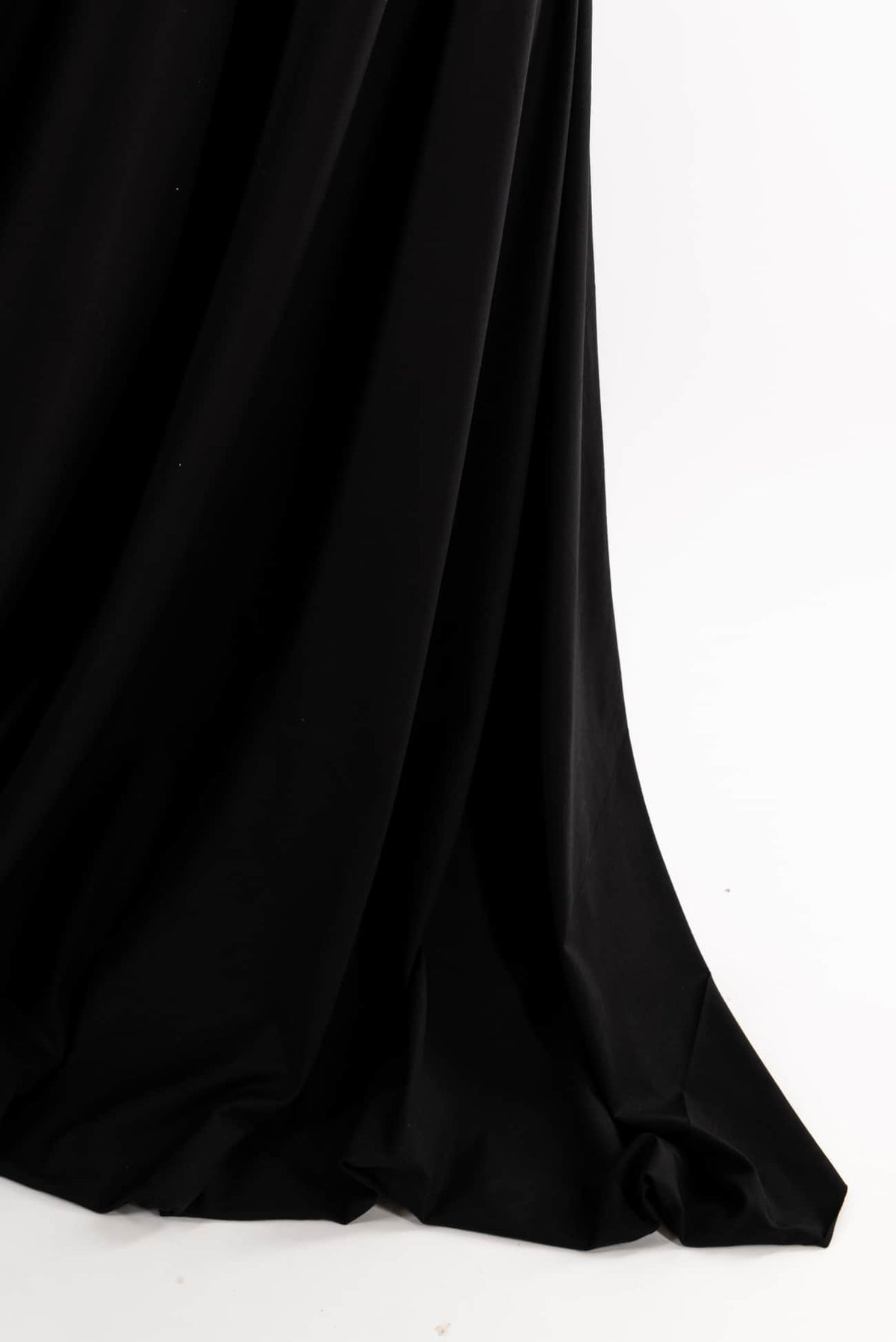 Black solid fabric with soft drape, ideal for apparel sewing and fashion projects