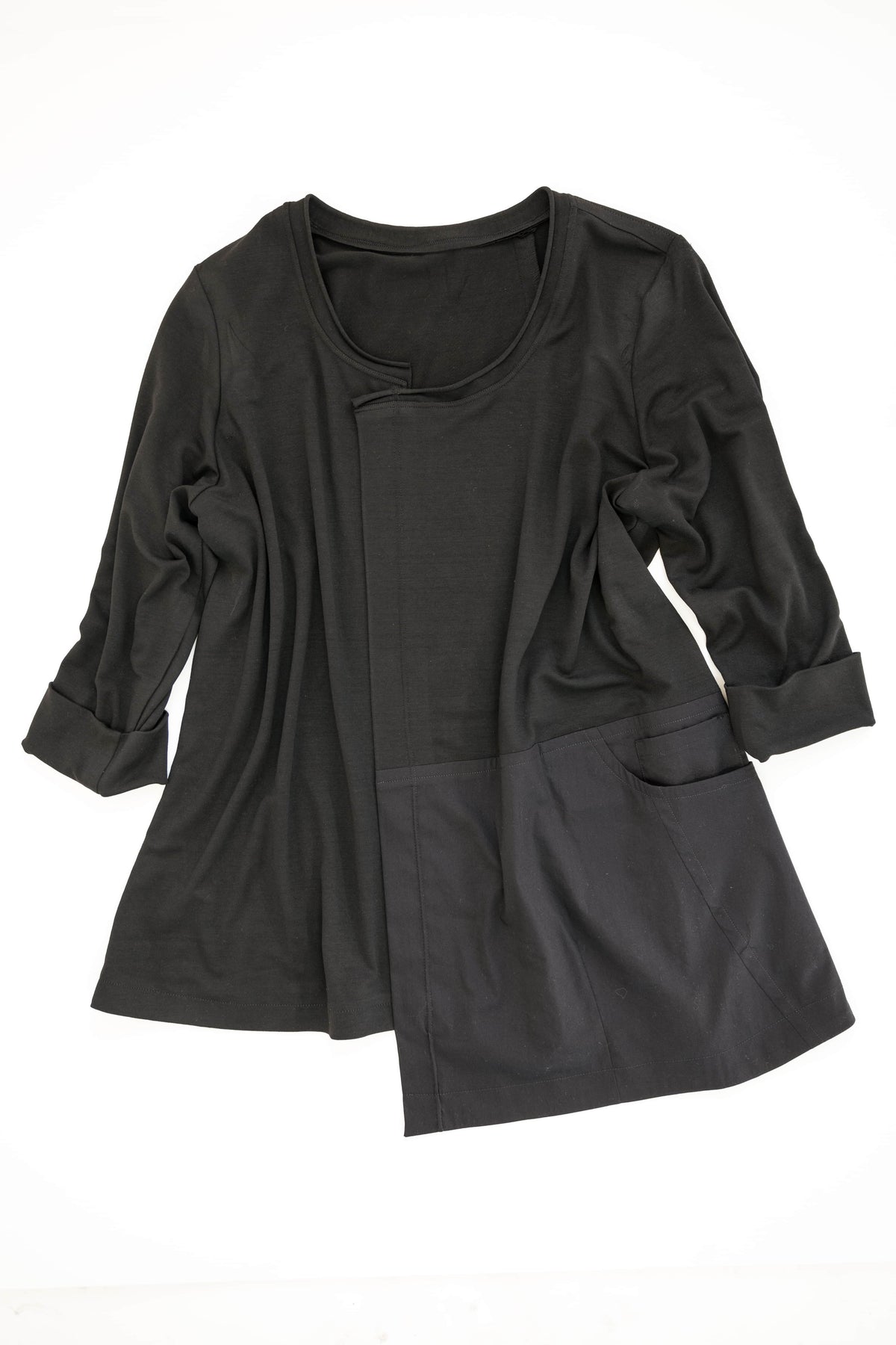Black long-sleeve tunic with asymmetrical hem and side pockets, ideal for sewing projects using knit or woven fabrics.