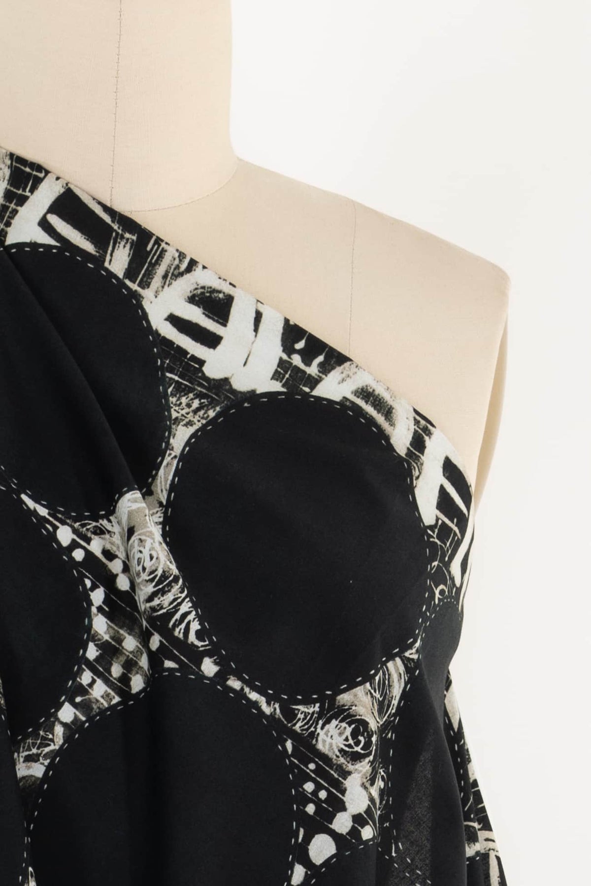 Black and white abstract printed fabric with geometric patterns, ideal for fashion sewing and apparel design