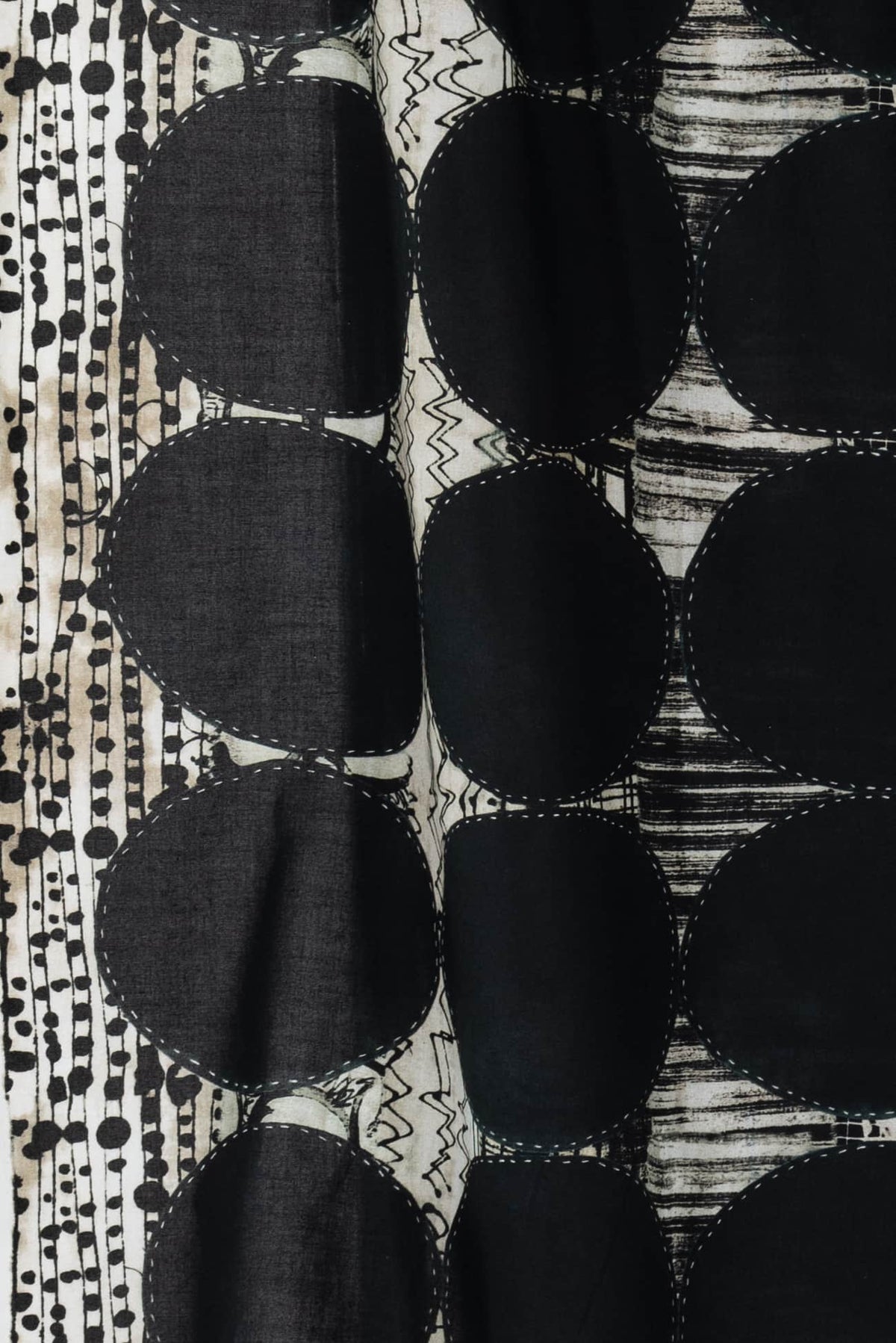 Black and white abstract fabric with geometric circles and textured patterns for sewing and quilting