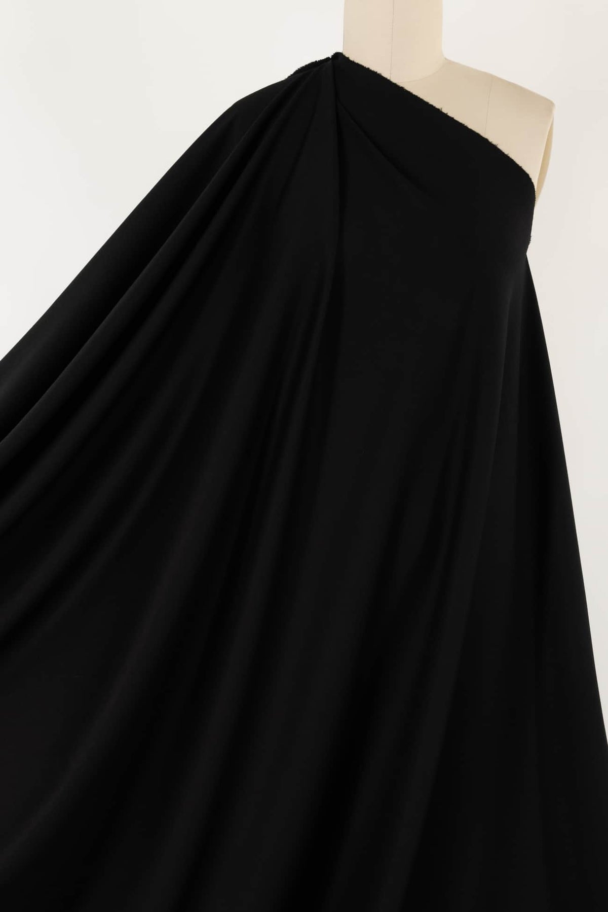 Black drape fabric on mannequin, ideal for apparel sewing and fashion design projects