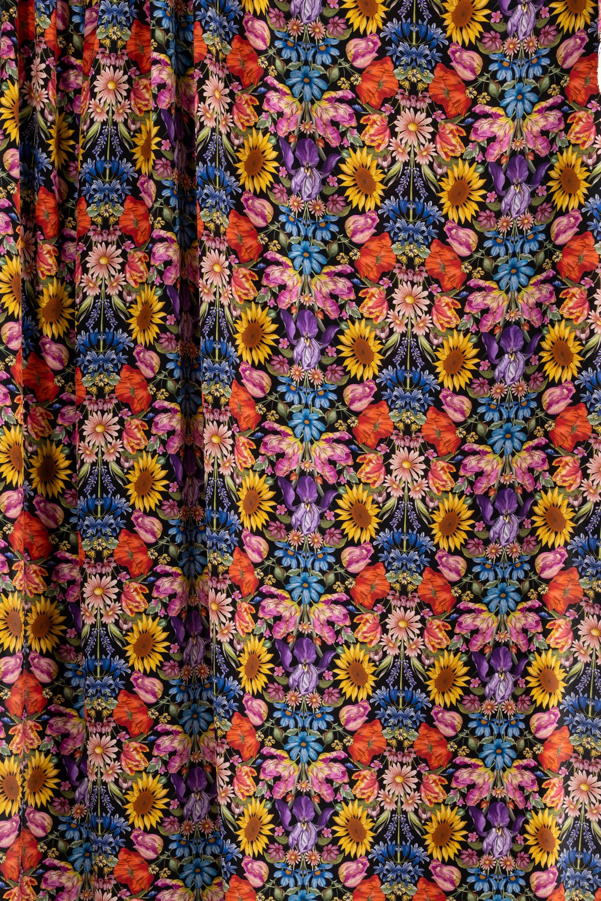 Vibrant floral fabric with sunflowers, poppies, and irises on black background — ideal for apparel and quilting