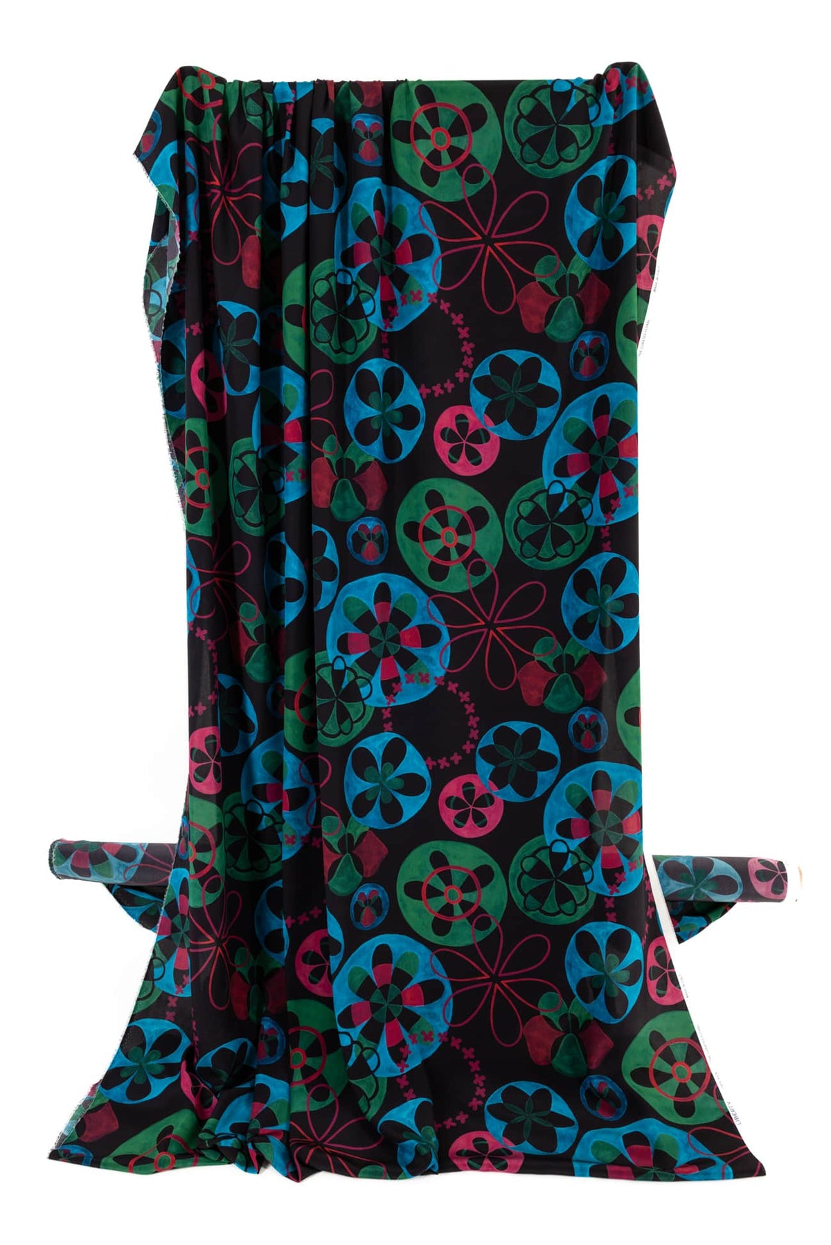 Vibrant floral and geometric print fabric in teal, green, pink on black background, ideal for apparel and quilting
