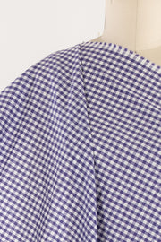 Purple and white gingham check fabric draped on mannequin, ideal for apparel sewing projects