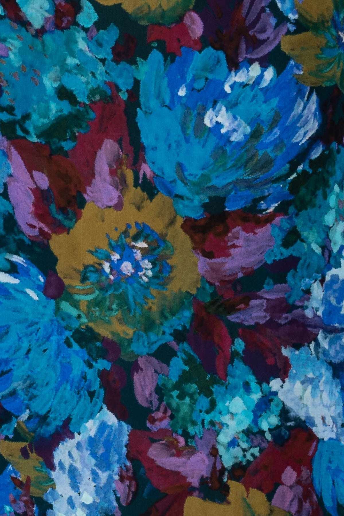 Vibrant floral print fabric with bold blue, red, and gold hues, ideal for apparel and quilting projects.