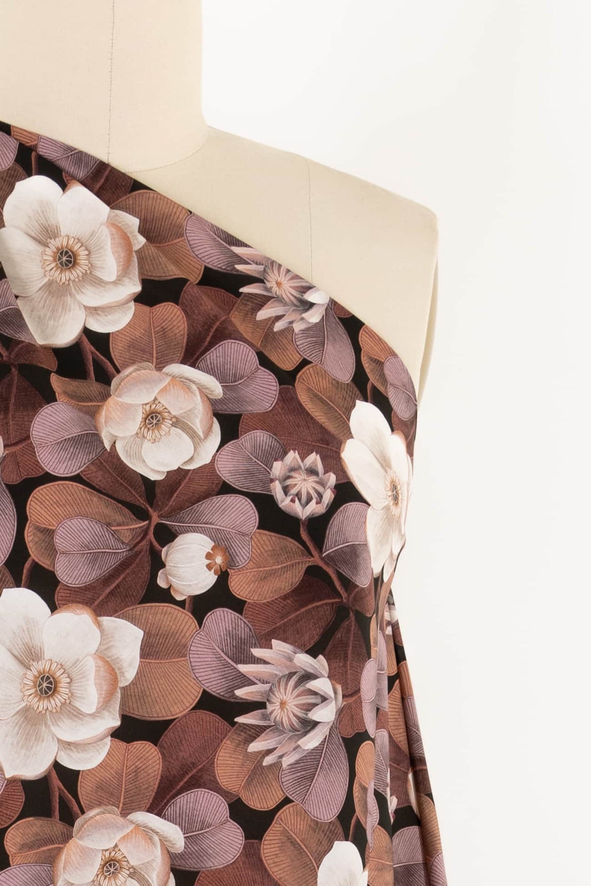 Floral print fabric with white flowers and brown leaves on mannequin, ideal for apparel sewing