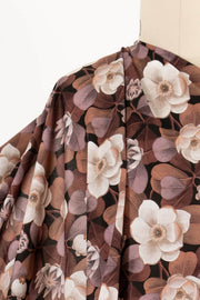 Elegant floral fabric with cream blooms and brown leaves, ideal for apparel and quilting projects