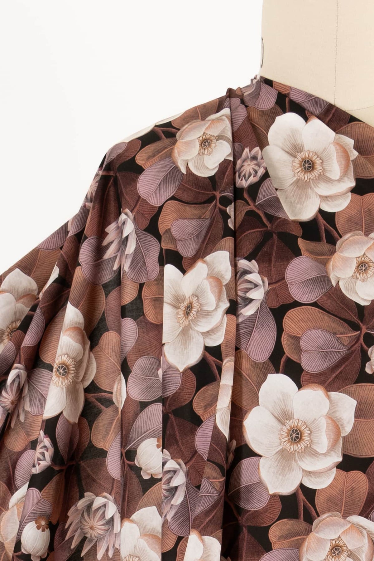Elegant floral fabric with cream blooms and brown leaves, ideal for apparel and quilting projects