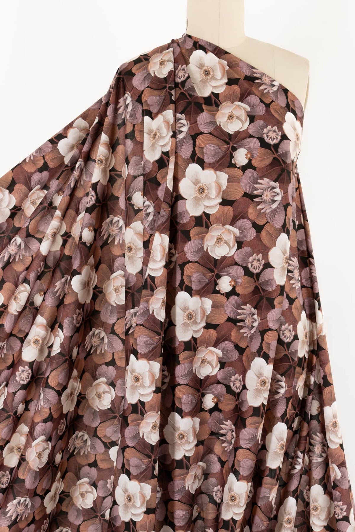 Floral print fabric with cream flowers and brown leaves on mannequin, ideal for apparel sewing