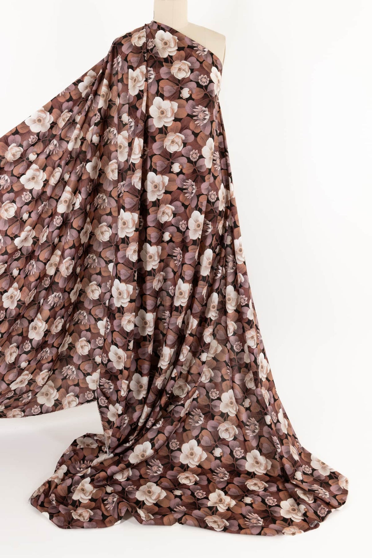 Brown floral print fabric draped on mannequin, ideal for apparel sewing and fashion projects