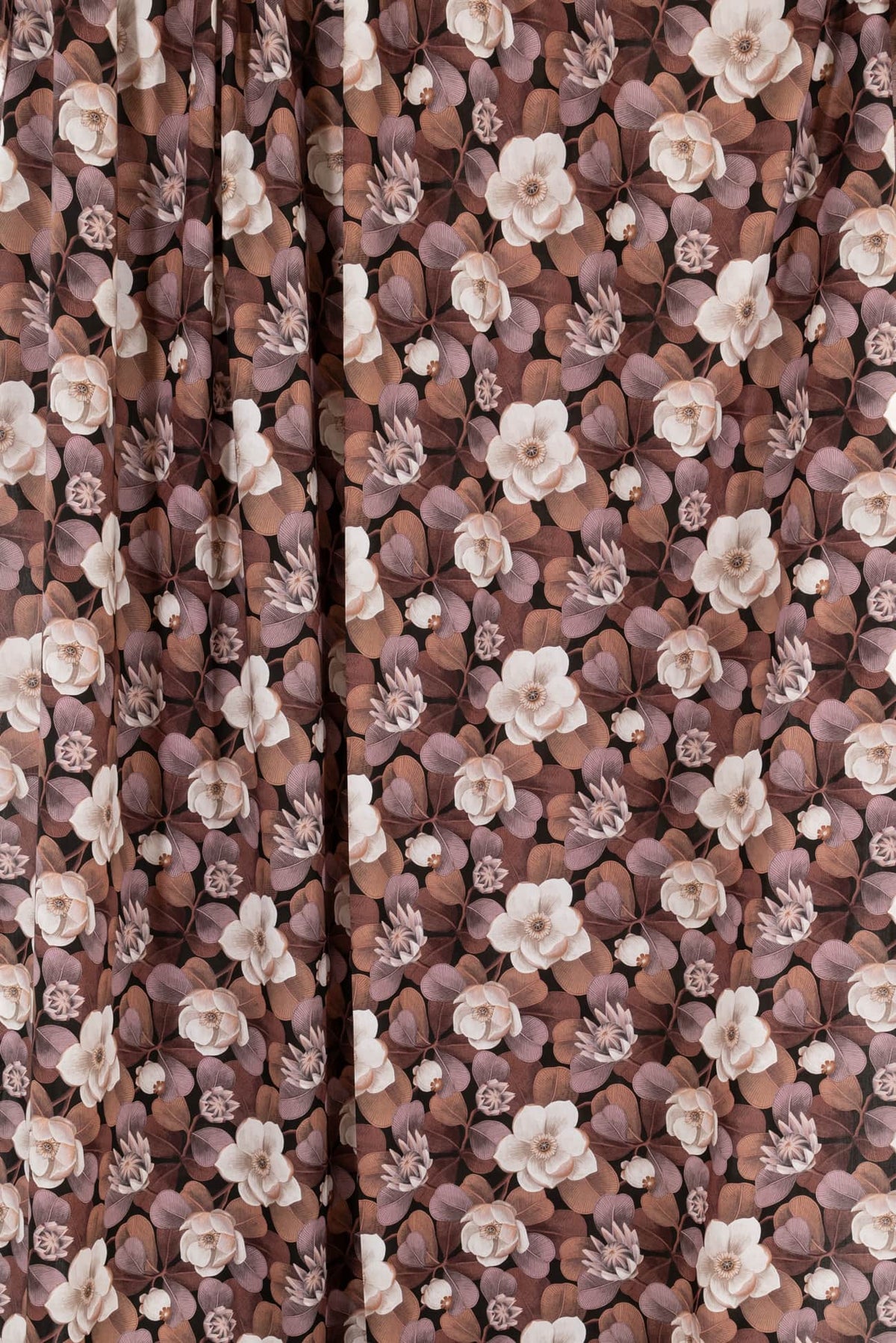 Elegant floral fabric with cream blooms and mauve leaves on dark background, ideal for apparel and quilting