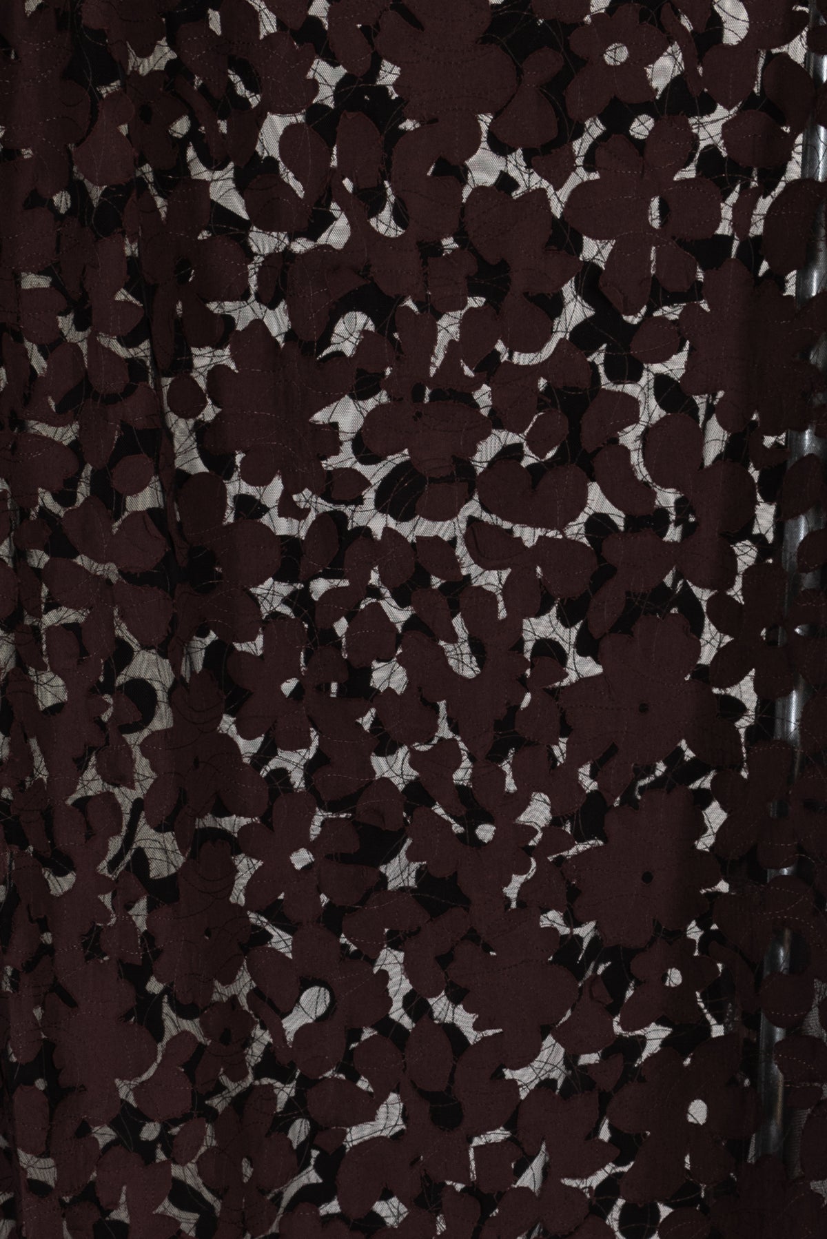 Dark burgundy floral lace fabric with sheer mesh background, ideal for apparel and creative sewing projects.