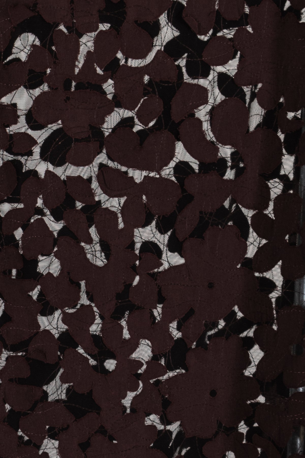 Dark floral lace fabric with sheer mesh background, ideal for apparel and creative sewing projects.