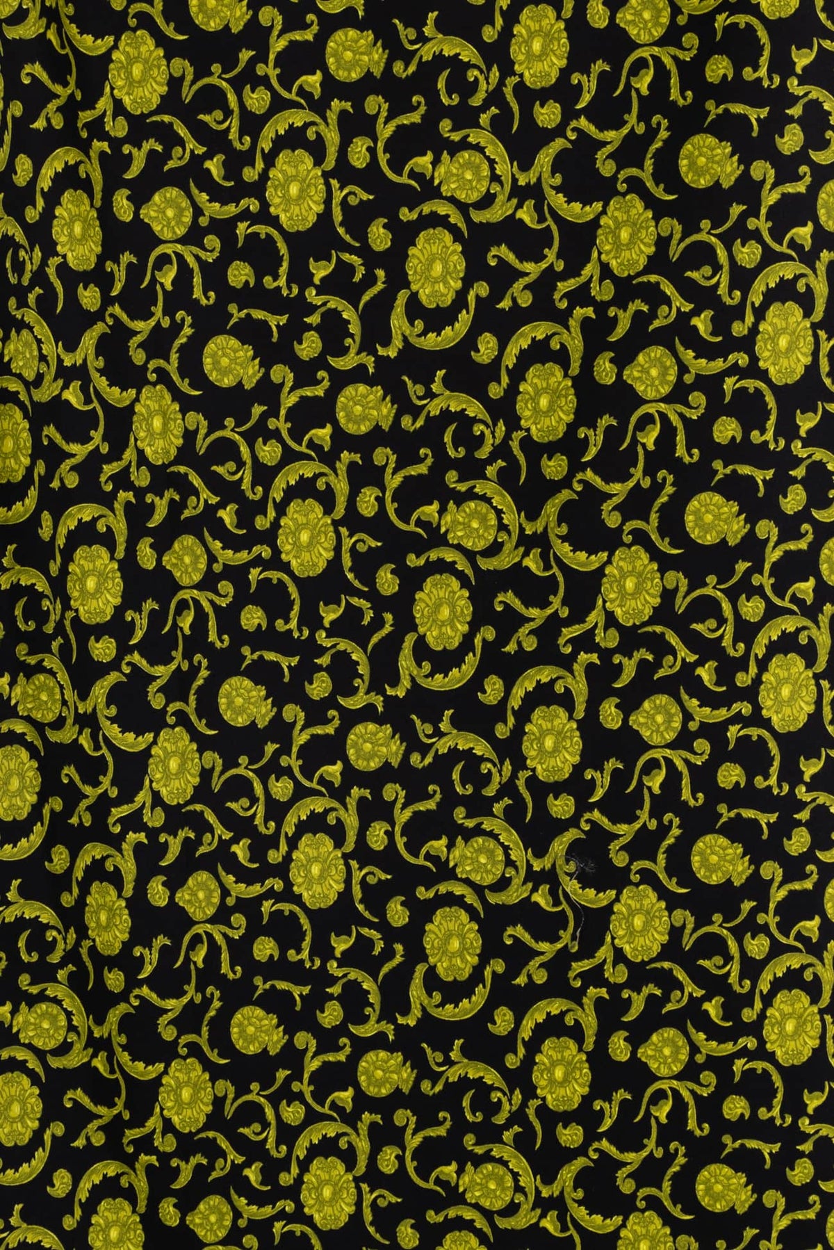 Black fabric with vibrant yellow floral vine pattern, ideal for apparel and sewing projects